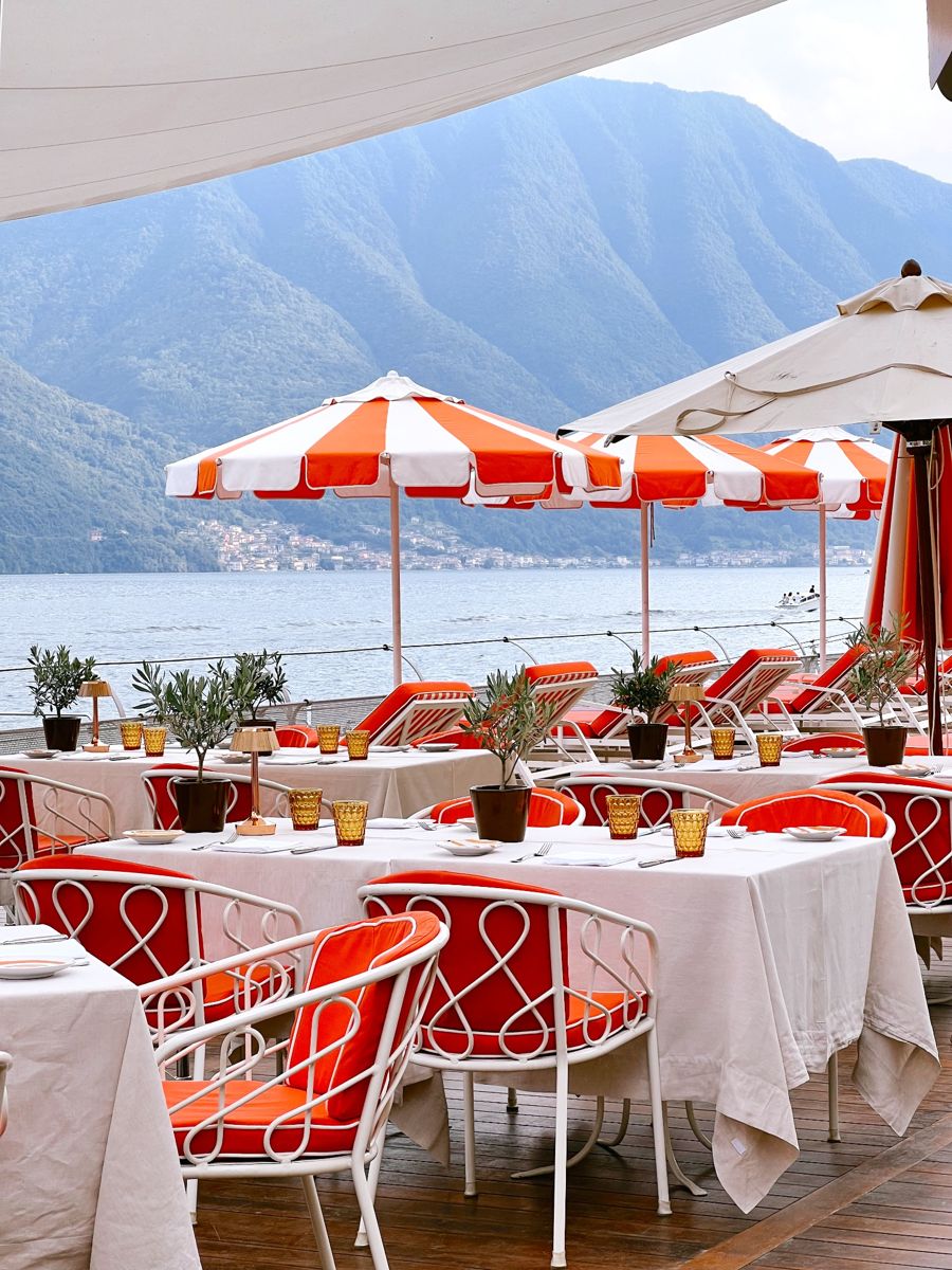 Lakeside dining terrace with striped umbrellas